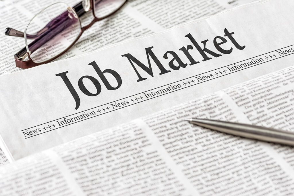 A newspaper with the headline Job Market